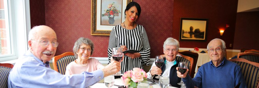 A toast before dinner with waitress ready to take order